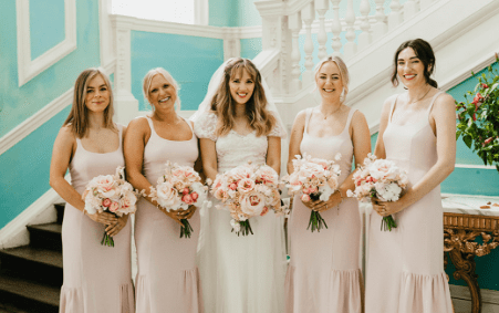 bridal party holding their wedding flowers