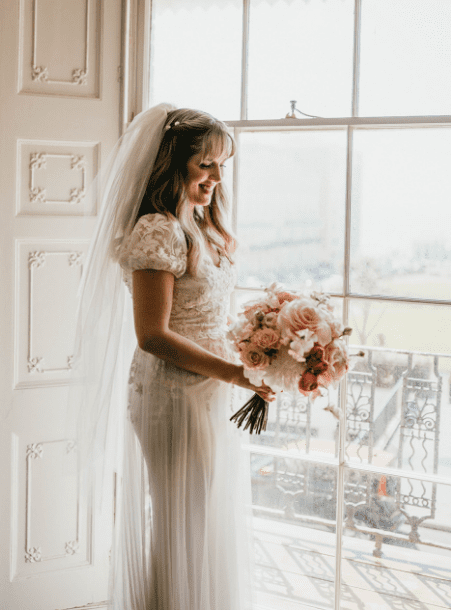happy bride with bouquet of wedding flowers