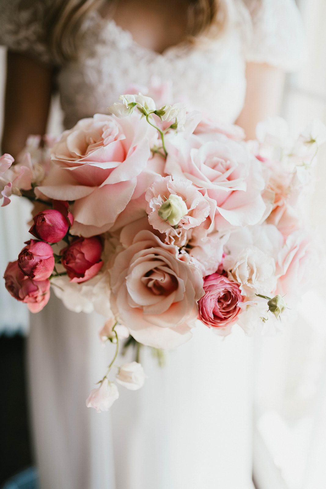 Bride holding out her bridal bouquet of wedding flowers